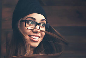 Junge Frau zeigt ihre zahnfarbene Zahnspange